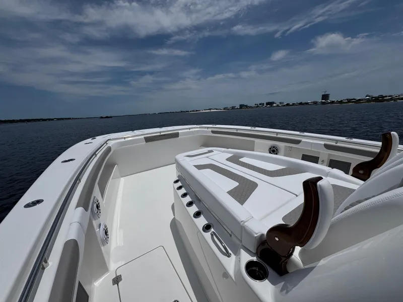 Slide: The Image of 2026 Caymas 44 CT boat on calm water under a partly cloudy sky. - 23