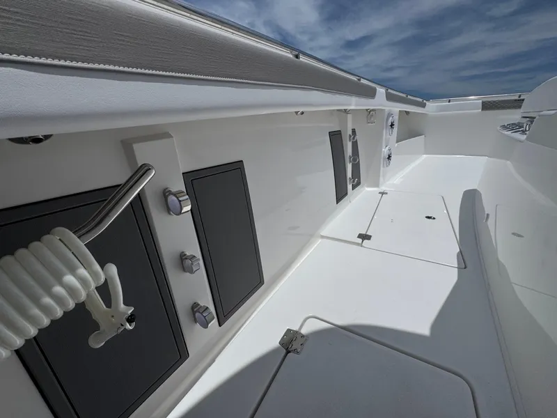 Slide: The Image of 2026 Caymas 44 CT boat deck with storage compartments and sleek design. - 29