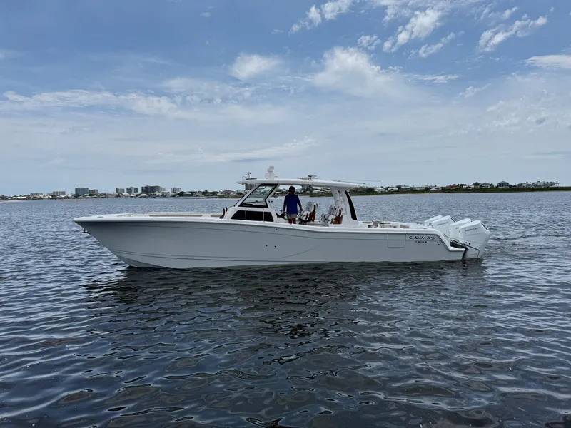 Slide: The Image of 2026 Caymas 44 CT boat on calm water under a partly cloudy sky. - 3