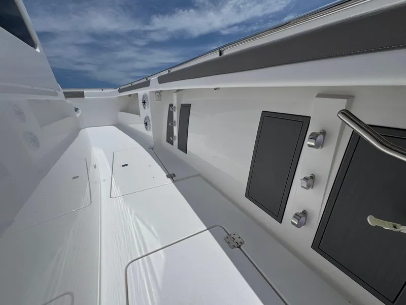 Slide: The Image of 2026 Caymas 44 CT boat deck with sleek design and modern features under a clear sky. - 30