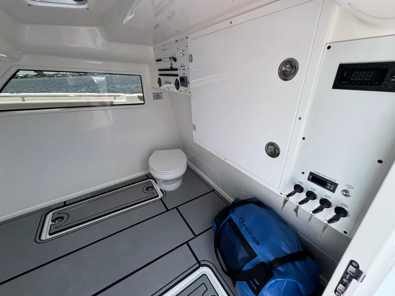 Slide: The Image of Interior of 2026 Caymas 44 CT boat cabin with toilet and blue bag. - 31