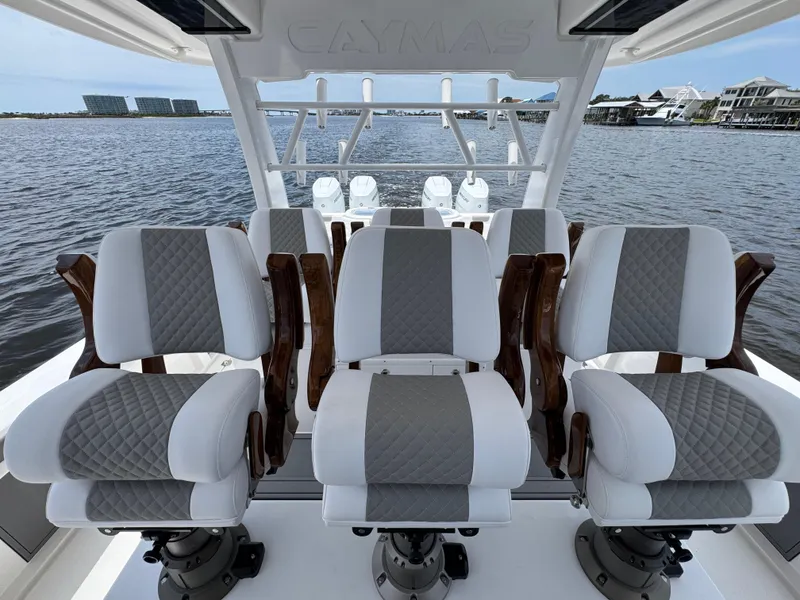 Slide: The Image of 2026 Caymas 44 CT boat interior with luxurious seating, overlooking a serene waterfront. - 34