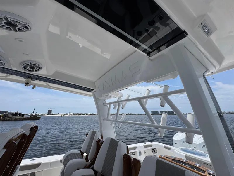 Slide: The Image of 2026 Caymas 44 CT boat interior with seating, rod holders, and water view. - 40