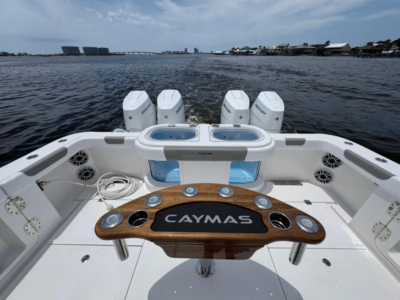 Slide: The Image of 2026 Caymas 44 CT boat with multiple engines, wooden deck, and ocean view. - 45