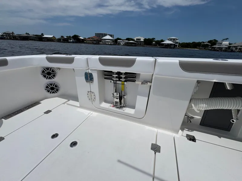 Slide: The Image of 2026 Caymas 44 CT boat deck with storage compartments and speakers, overlooking a waterfront view. - 46