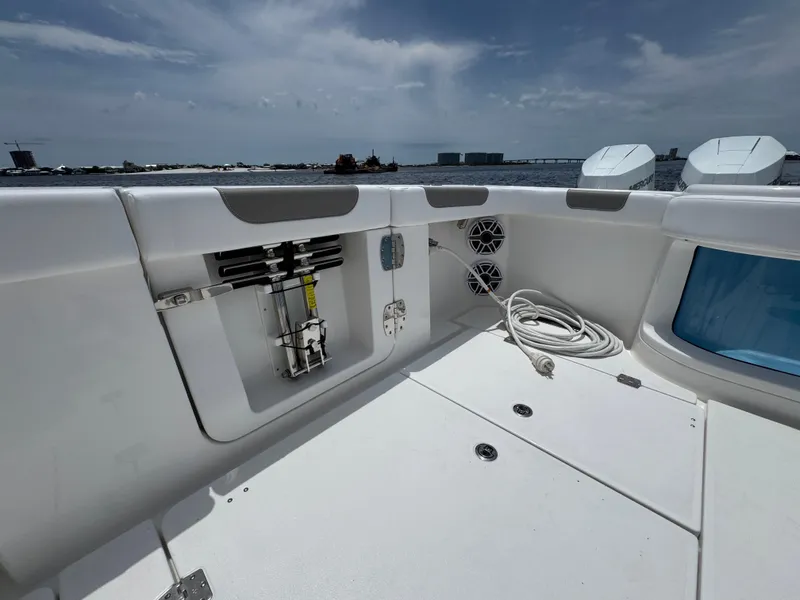 Slide: The Image of 2026 Caymas 44 CT boat deck with storage compartments and coiled rope, under a clear sky. - 47