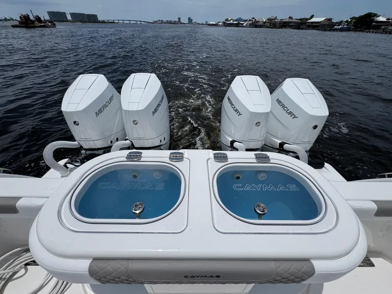 Slide: The Image of 2026 Caymas 44 CT boat with Mercury engines on a scenic waterway. - 49