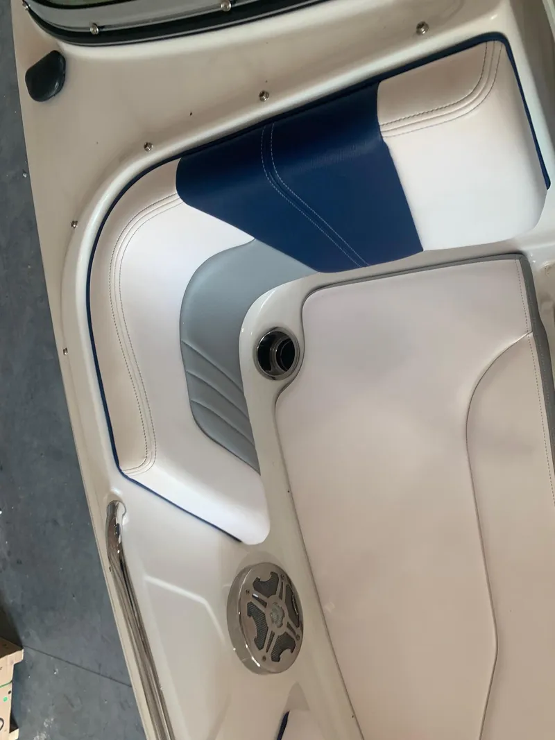 Slide: The Image of 2020 Chaparral 21 Surf boat interior with blue and white seating. - 16