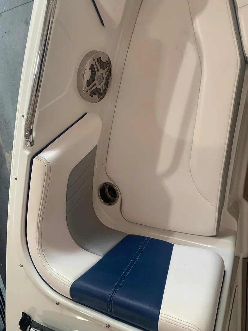 Slide: The Image of 2020 Chaparral 21 Surf boat interior with white and blue seating. - 20