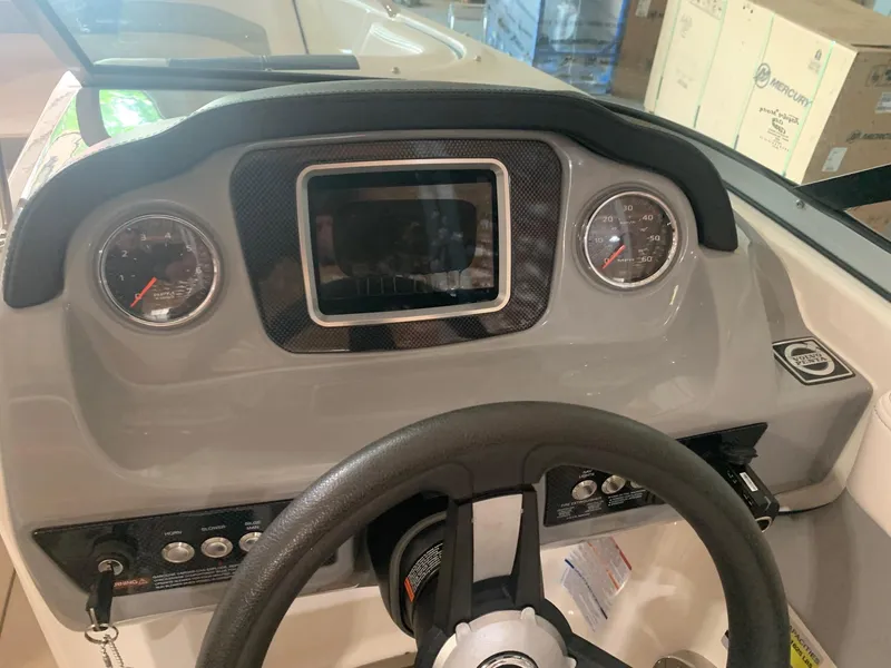 Slide: The Image of Dashboard of 2020 Chaparral 21 Surf boat with steering wheel and gauges. - 22