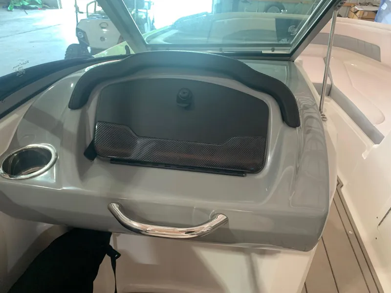 Slide: The Image of 2020 Chaparral 21 Surf boat dashboard with storage compartment and cup holder. - 23
