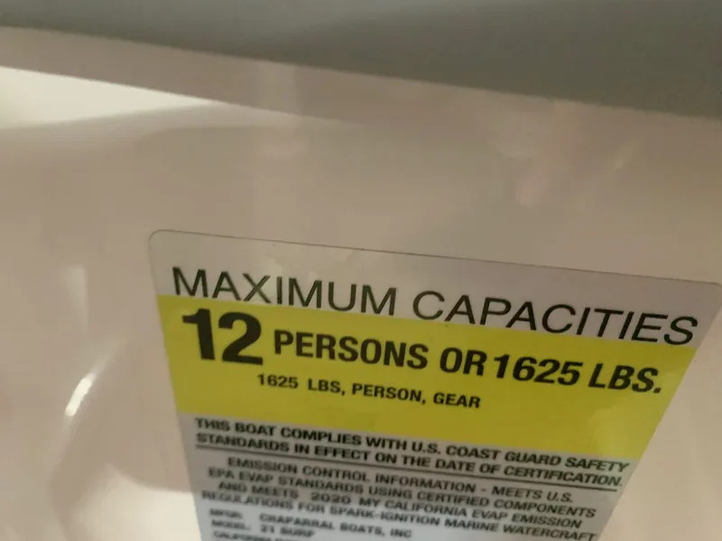 Slide: The Image of 2020 Chaparral 21 Surf boat capacity label: 12 persons or 1625 lbs maximum. - 24