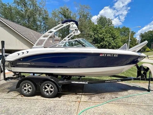 Slide: The Image of 2020 Chaparral 21 Surf boat on trailer, parked in driveway, sunny day. - 3