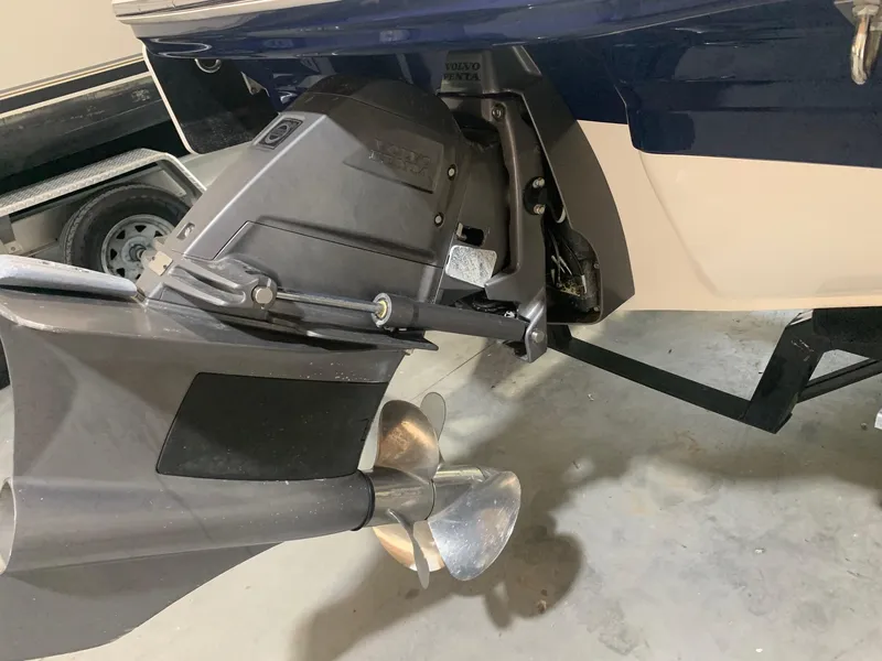 Slide: The Image of 2020 Chaparral 21 Surf boat's propeller and stern drive in a garage setting. - 7