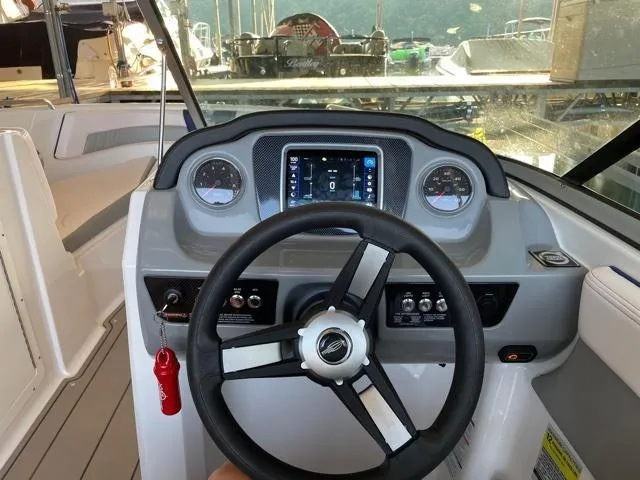 Slide: The Image of 2020 Chaparral 21 Surf boat dashboard with steering wheel and control panel. - 8