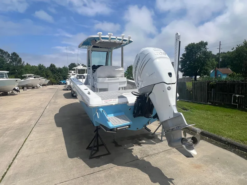 Slide: The Image of 2023 Everglades 253 CC boat with outboard motor on a sunny day. - 3