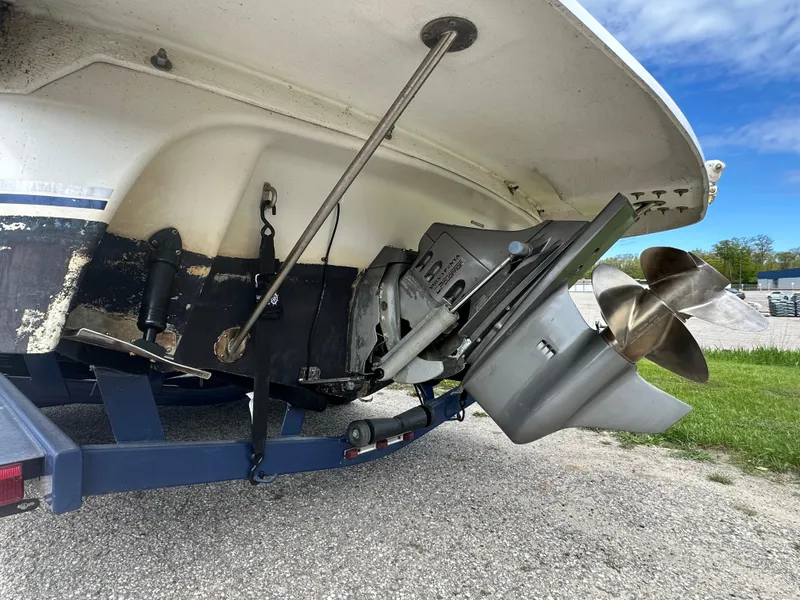 Slide: The Image of 2002 Four Winns 268 Vista boat stern with propeller and trailer on pavement. - 10