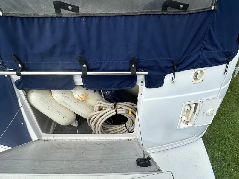Slide: The Image of 2002 Four Winns 268 Vista boat storage compartment with ropes and fenders. - 12
