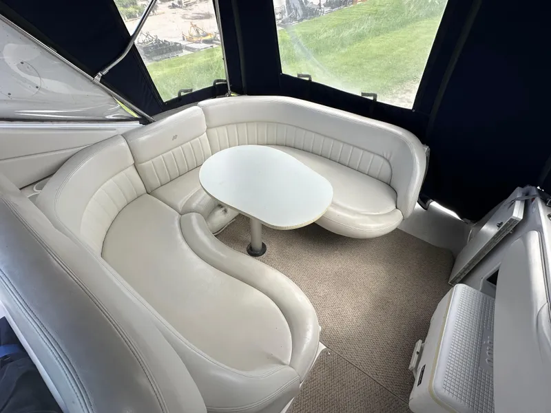 Slide: The Image of 2002 Four Winns 268 Vista boat interior with white leather seating and table. - 13
