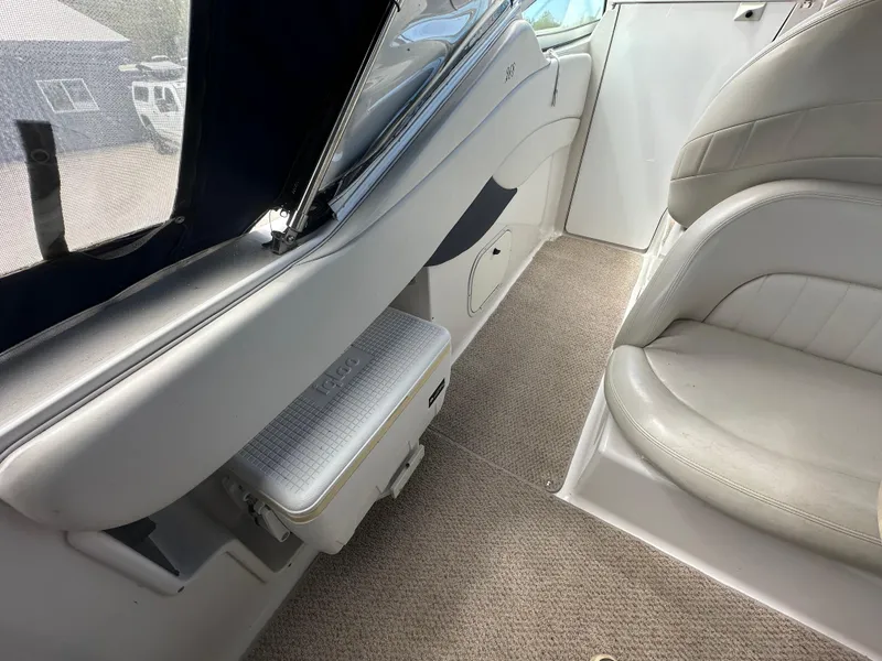 Slide: The Image of Interior of 2002 Four Winns 268 Vista boat, featuring beige seating and carpeted flooring. - 15