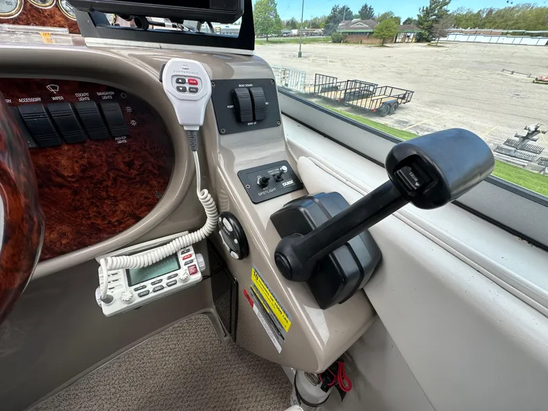 Slide: The Image of 2002 Four Winns 268 Vista boat control panel with throttle and communication devices. - 23