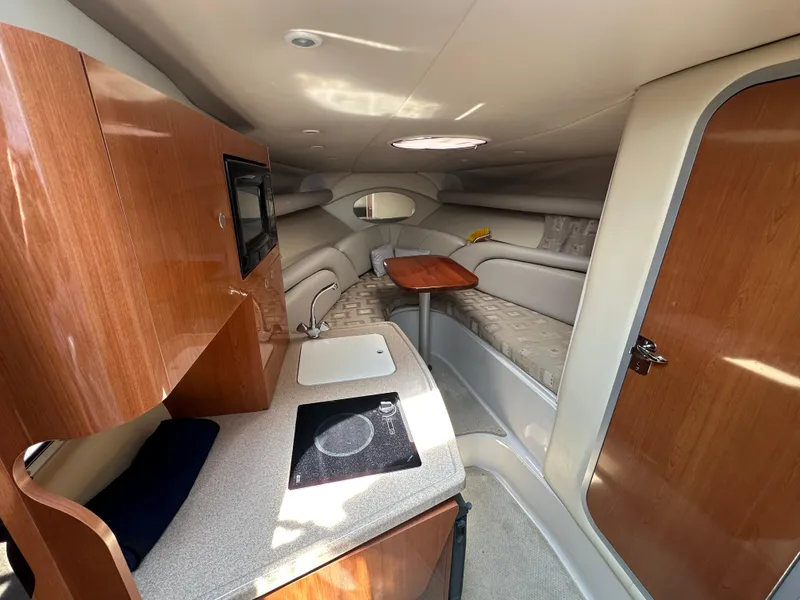 Slide: The Image of Interior of 2002 Four Winns 268 Vista boat with kitchenette and seating area. - 26