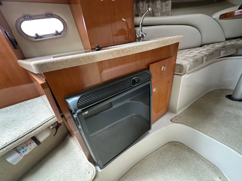 Slide: The Image of 2002 Four Winns 268 Vista cabin interior with kitchenette and seating area. - 29