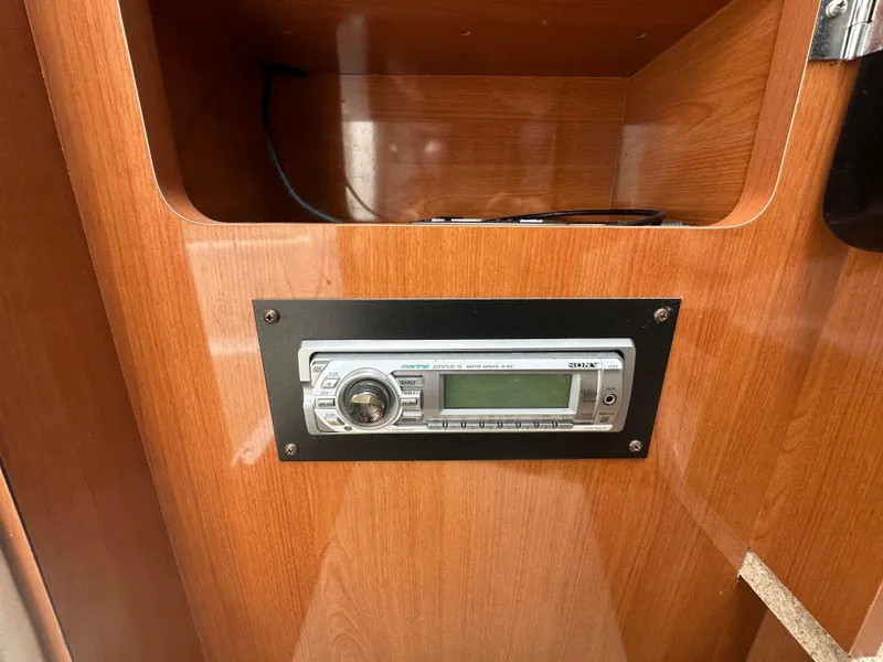 Slide: The Image of 2002 Four Winns 268 Vista cabin with built-in stereo system on wooden panel. - 31