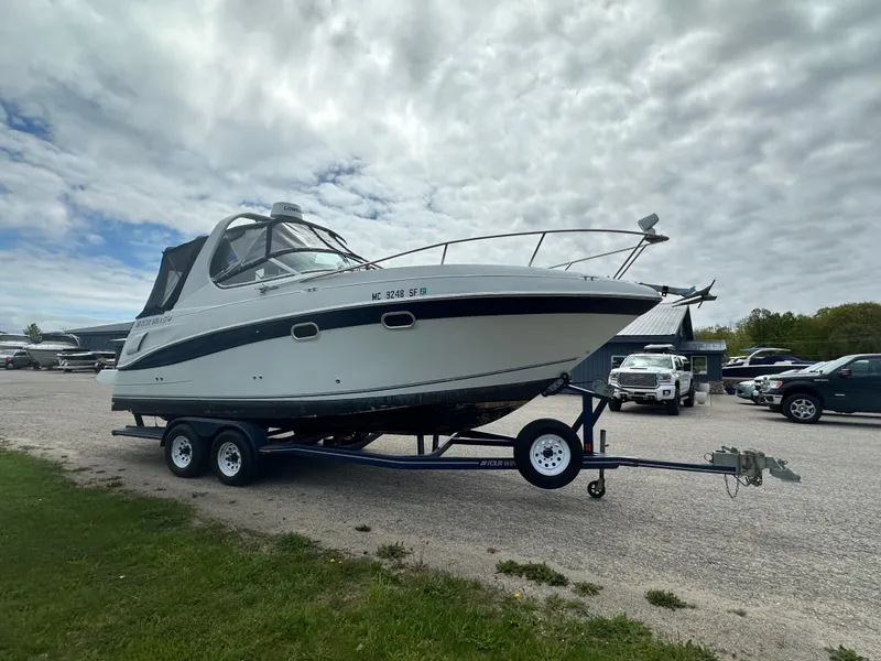 Slide: The Image of 2002 Four Winns 268 Vista boat on trailer under cloudy sky. - 6