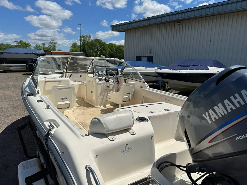 Slide: The Image of 2003 Sea Hunt Escape 186 boat with Yamaha outboard motor, parked outdoors. - 13