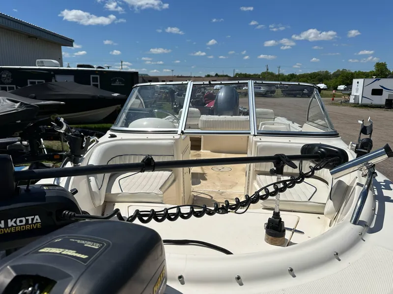 Slide: The Image of 2003 Sea Hunt Escape 186 boat with open deck, parked outdoors under a clear sky. - 9