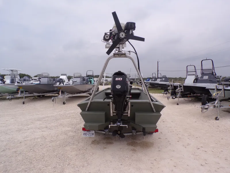 Slide: The Image of 2024 Southfork 1662 EXLSF boat with motor, parked on gravel lot. - 10