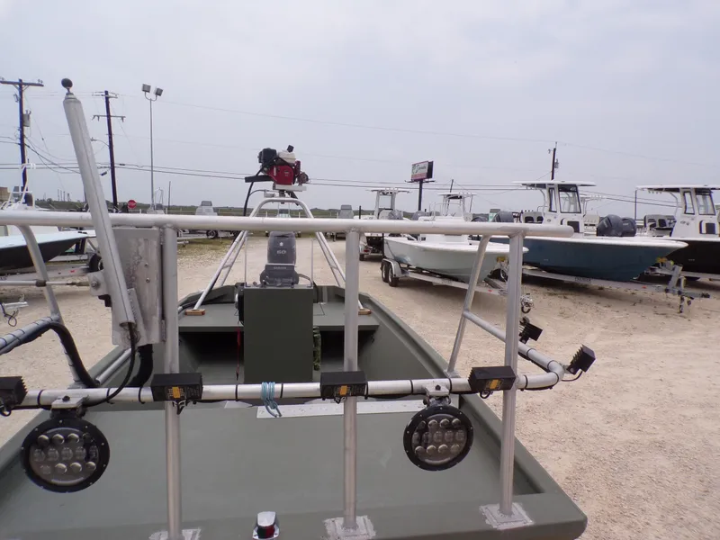 Slide: The Image of 2024 Southfork 1662 EXLSF boat in a dealership lot, surrounded by other boats. - 13