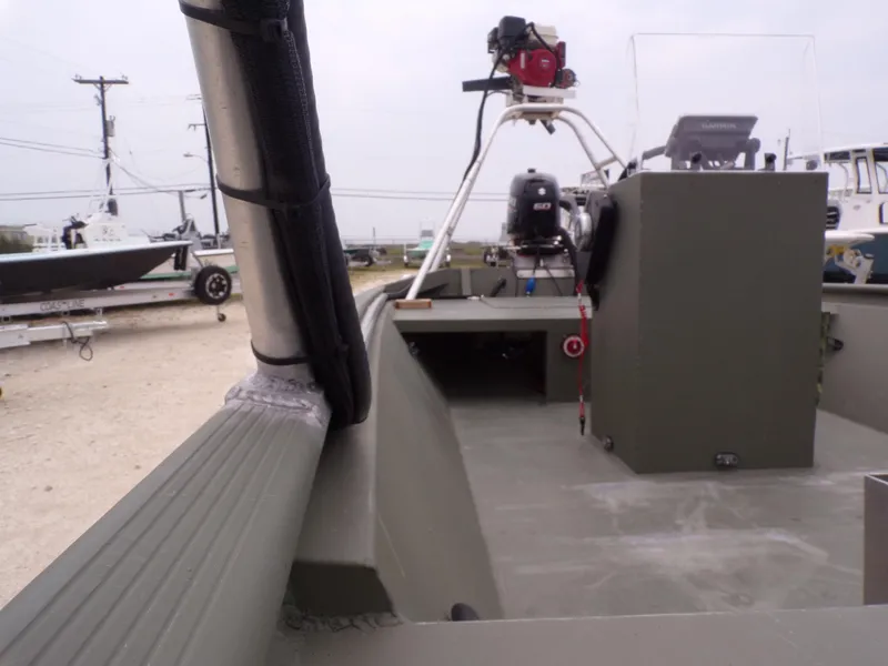 Slide: The Image of 2024 Southfork 1662 EXLSF boat interior with console and equipment, parked on a trailer. - 15