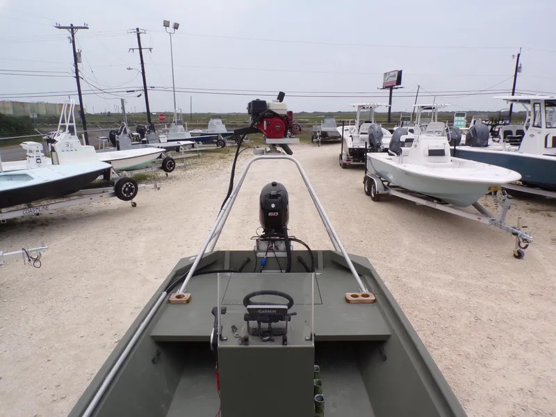 Slide: The Image of 2024 Southfork 1662 EXLSF boat in a dealership lot, surrounded by other boats. - 17