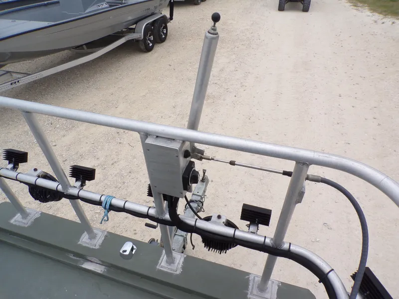 Slide: The Image of 2024 Southfork 1662 EXLSF boat with steering mechanism and trailer on gravel path. - 18