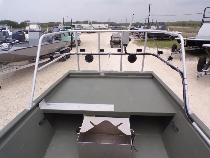 Slide: The Image of 2024 Southfork 1662 EXLSF boat with fishing setup, parked on gravel lot. - 19