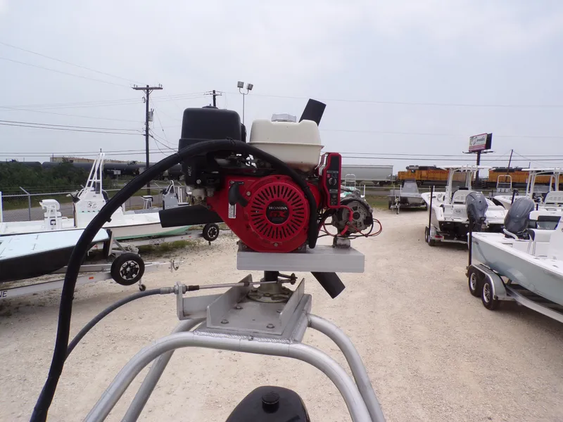 Slide: The Image of 2024 Southfork 1662 EXLSF boat engine, surrounded by various boats in a dealership lot. - 21