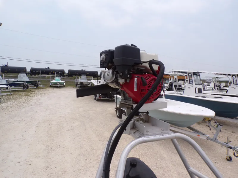 Slide: The Image of 2024 Southfork 1662 EXLSF boat with motor, displayed in a boatyard. - 22