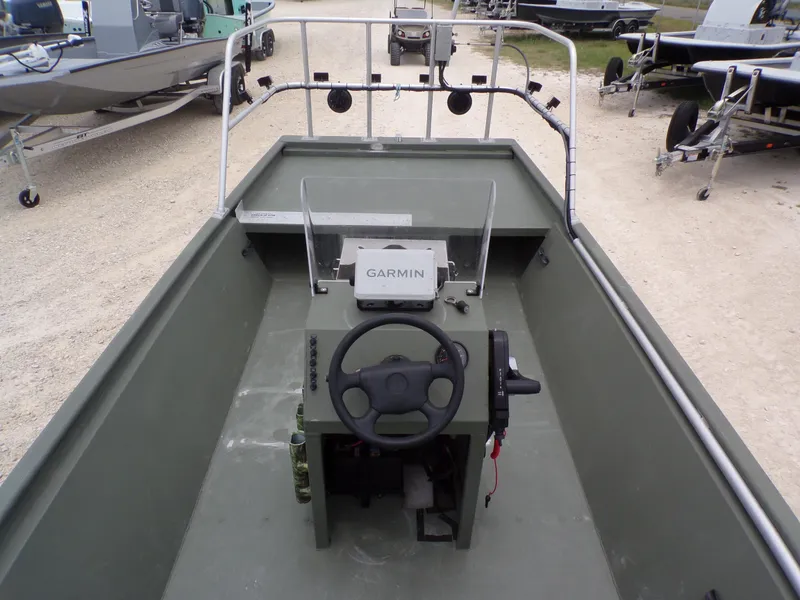 Slide: The Image of 2024 Southfork 1662 EXLSF boat interior with Garmin navigation system and steering wheel. - 23