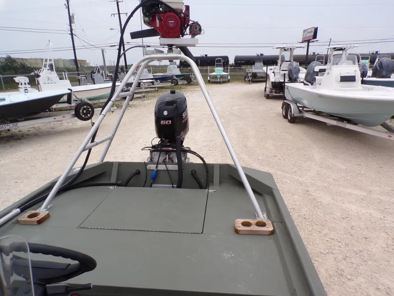 Slide: The Image of 2024 Southfork 1662 EXLSF boat with Suzuki engine, parked among other boats. - 24