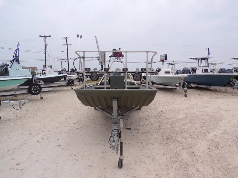 Slide: The Image of 2024 Southfork 1662 EXLSF boat on trailer, surrounded by other boats in a lot. - 5