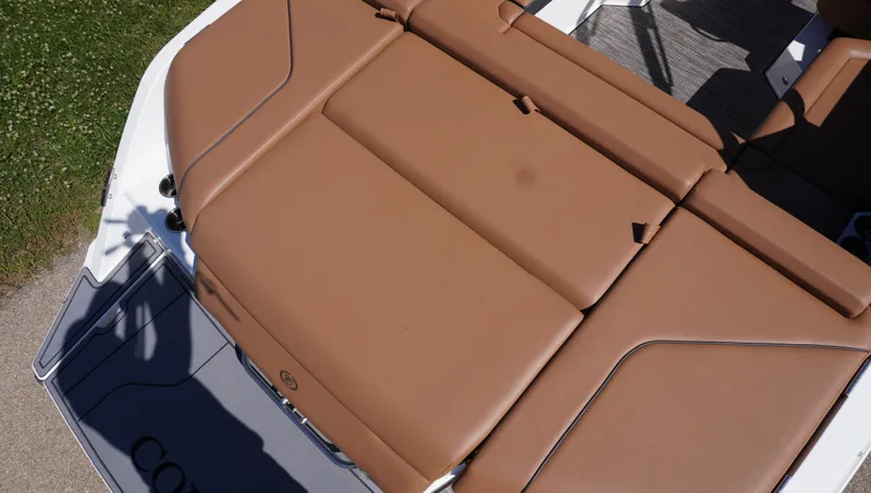 Slide: The Image of 2024 Cobalt CS23 boat with tan leather seating, viewed from above. - 10