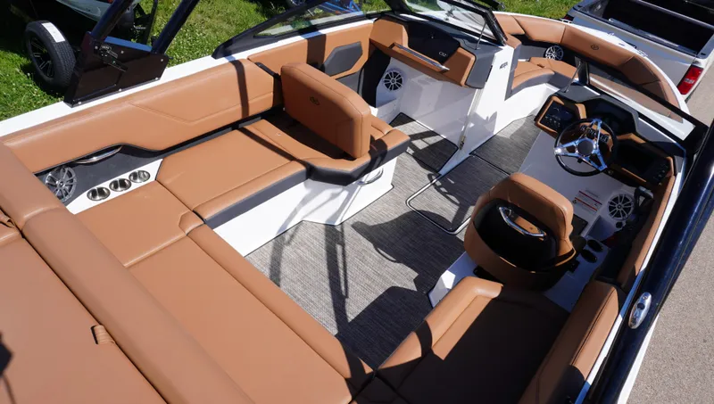 Slide: The Image of 2024 Cobalt CS23 boat interior with tan leather seats and modern dashboard design. - 12