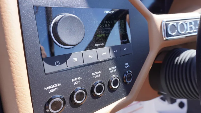 Slide: The Image of 2024 Cobalt CS23 boat dashboard with Fusion audio system and light controls. - 20