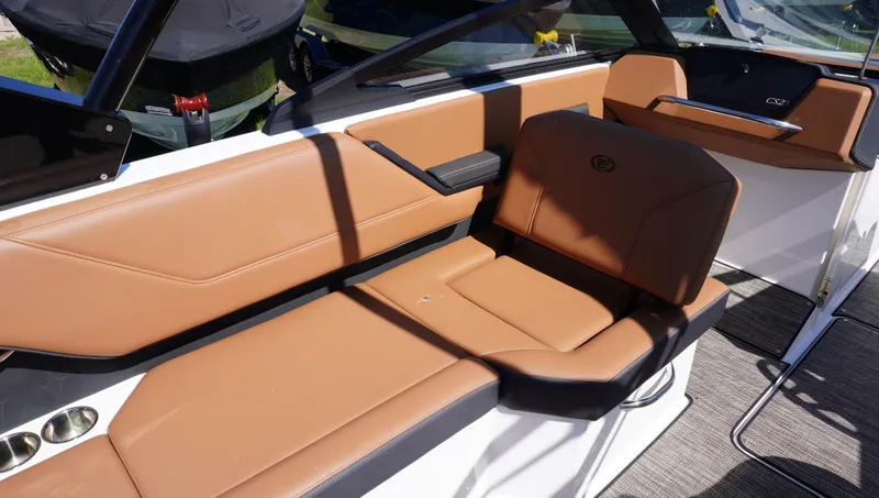 Slide: The Image of 2024 Cobalt CS23 boat interior with tan leather seating and modern design. - 25