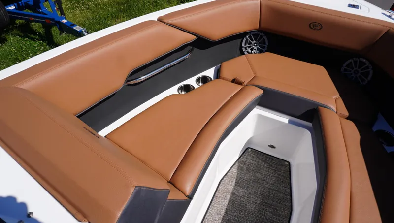 Slide: The Image of 2024 Cobalt CS23 boat interior with tan leather seating and modern design. - 27