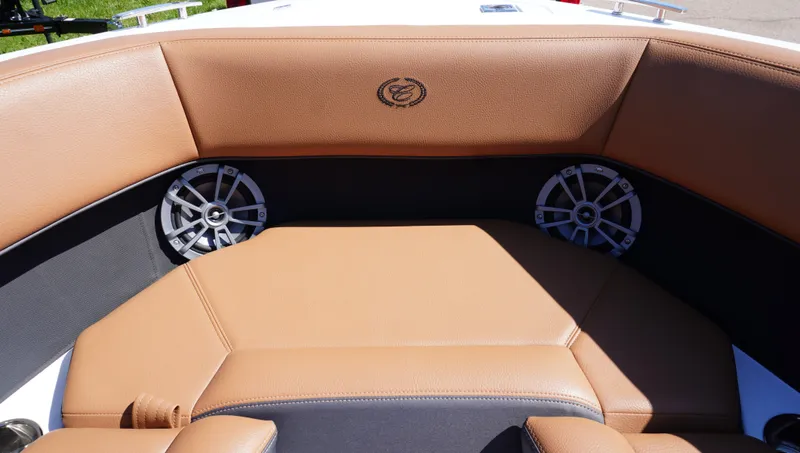 Slide: The Image of 2024 Cobalt CS23 boat interior with tan leather seating and built-in speakers. - 28