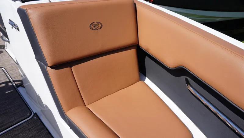 Slide: The Image of 2024 Cobalt CS23 boat seat with brown leather upholstery and logo detail. - 29