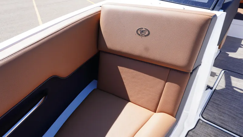 Slide: The Image of 2024 Cobalt CS23 boat interior with brown leather seating and logo detail. - 30